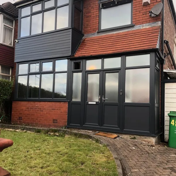 House front with new anthracite windows and doors