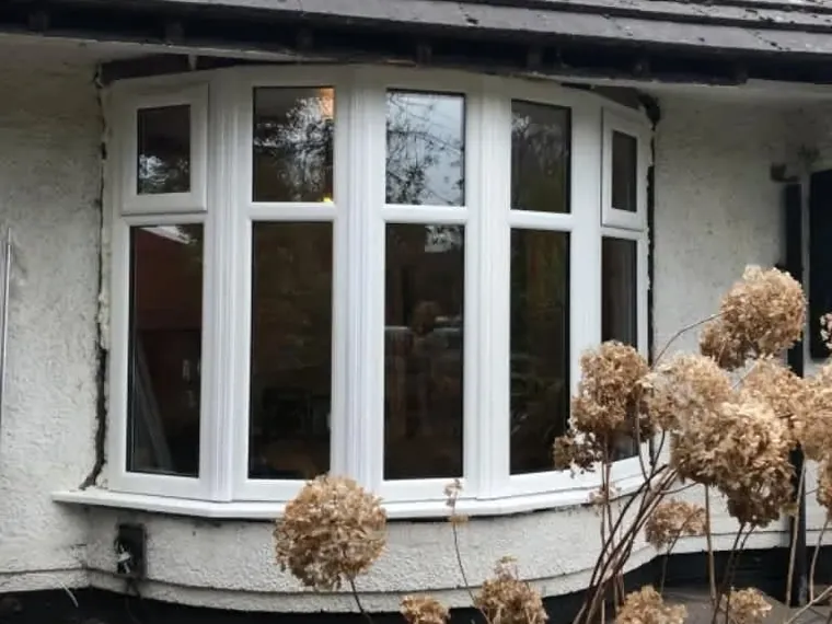 A white uPVC bay window on a bungalow