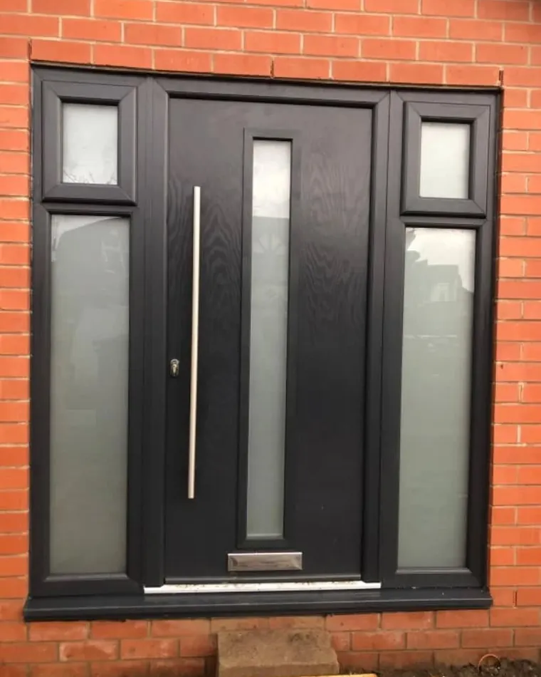 A black composite front door with glazed side panels