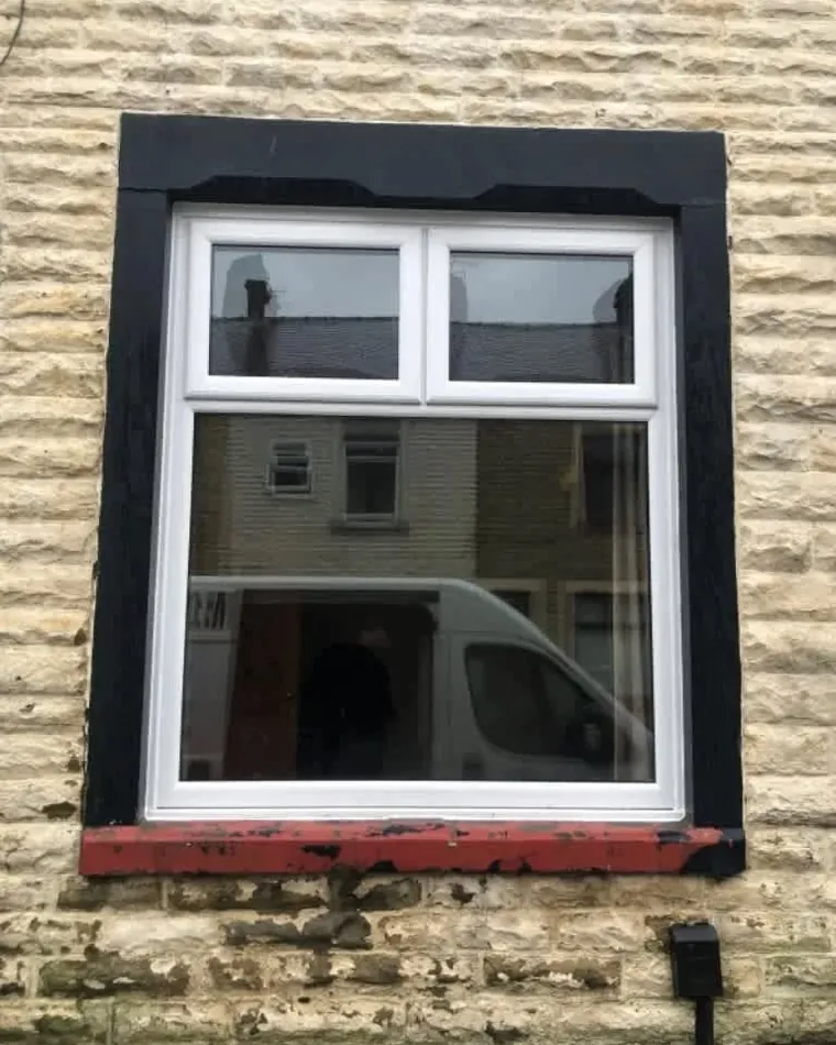 A new white uPVC window fitted into a stone wall