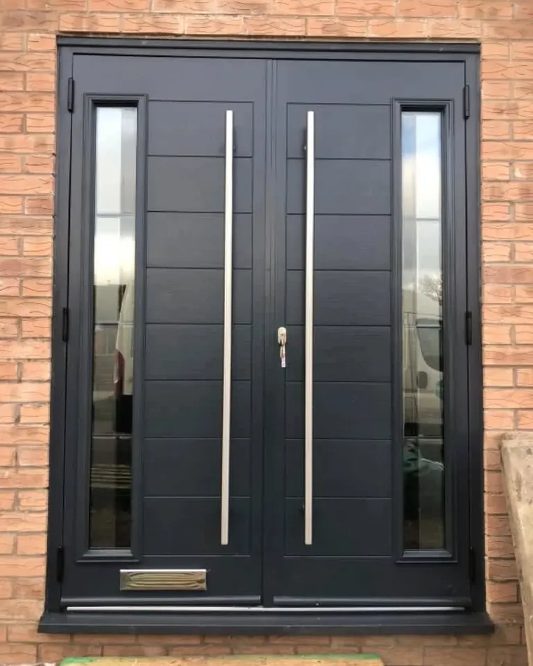 A black composite double front door with long bar handles